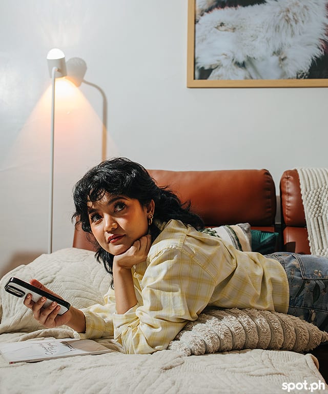 Lottie Bie on her couch with her phone